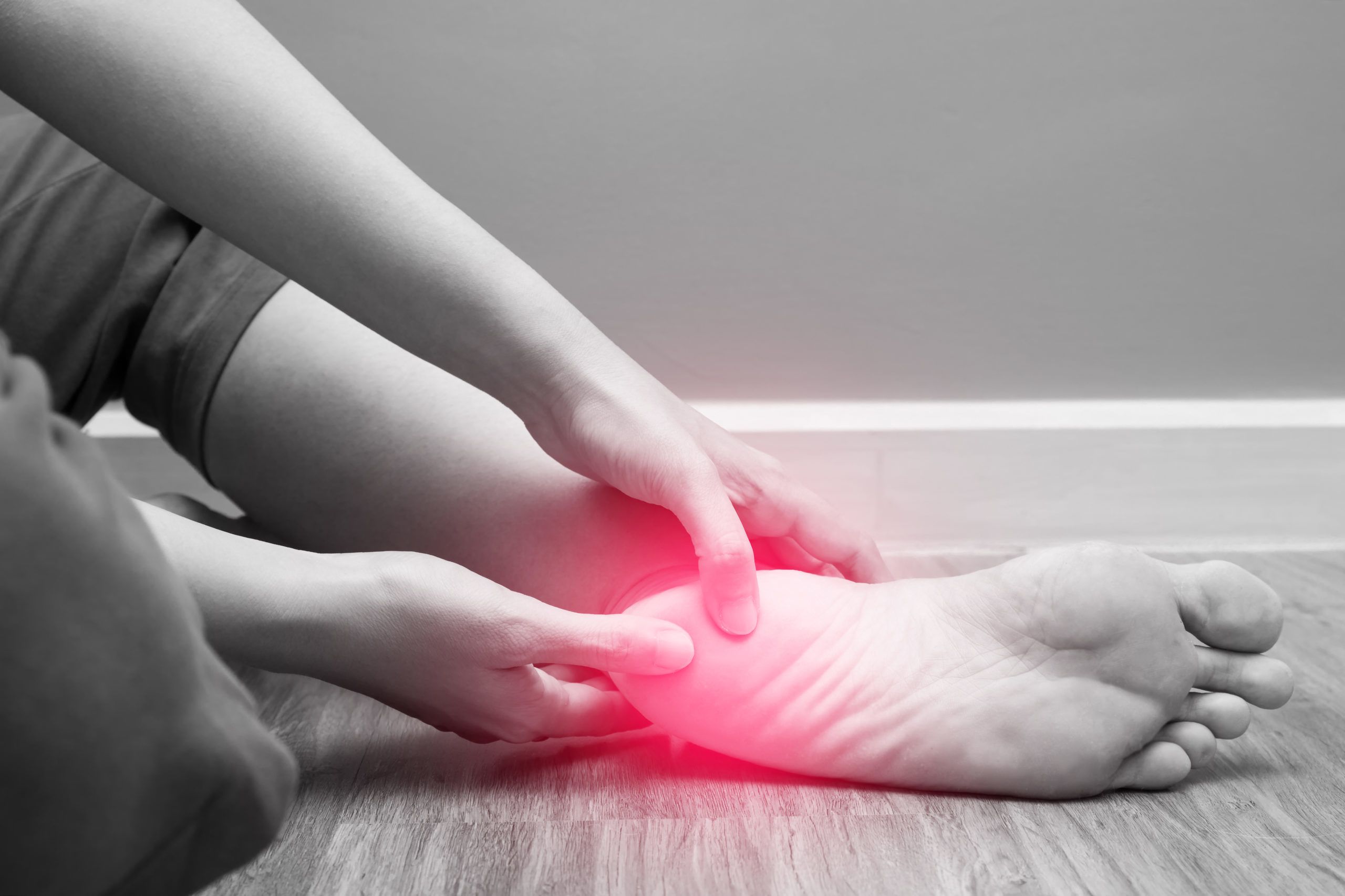 Female foot heel pain with red spot, plantar fasciitis