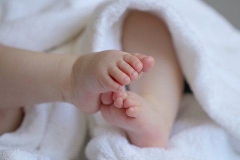 infant feet wrapped in a blanket
