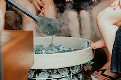 water being poured over hot rocks at a sauna in chicago, il